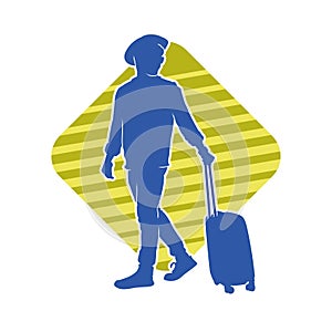 Silhouette of a male traveller with wheeled luggage case.