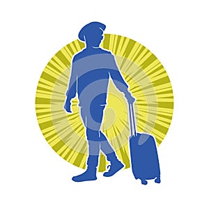 Silhouette of a male traveller with wheeled luggage case.