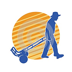 Silhouette of a male worker pulling a wheeled lori or hand truck equipment.