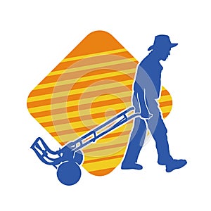 Silhouette of a male worker pulling a wheeled lori or hand truck equipment.