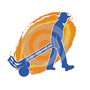 Silhouette of a male worker pulling a wheeled lori or hand truck equipment.