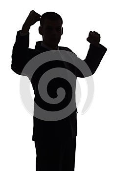 Silhouette of man with arms up