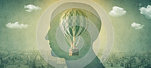 Silhouette of a man with a balloon, an aerostat as a symbol of freedom of thought. Concept , idea on the theme of psychiatry,