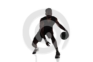 Silhouette of man, basketball player in motion during game, dribble ball, training isolated on white background