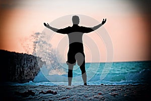 Silhouette of a man and the beautiful sunset on the beach