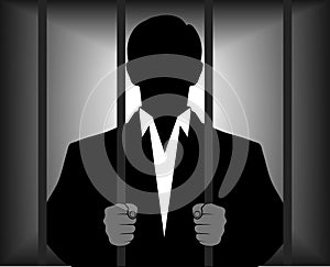 Silhouette of a man behind bars