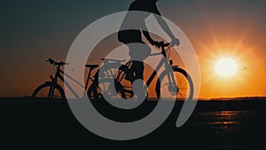 Silhouette of a Man on a Bicycle at Sunset Alone