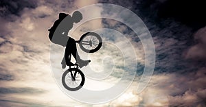 Silhouette of a man with bmx bike.