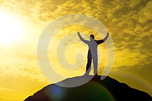 Silhouette of Man Celebration Success Happiness on a mountain top Evening Sky Sunset Background