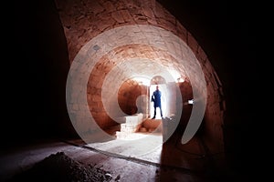 Silhouette of man in crypt photo