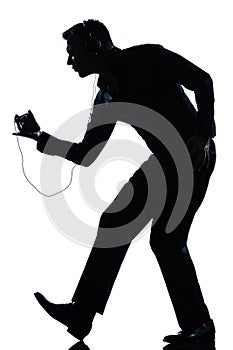 Silhouette man dancing listening to music