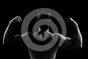 Silhouette of a man doing strength sword black background