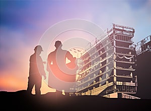 Silhouette man engineer looking construction worker in a building site over Blurred construction worker on construction site