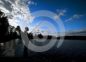 Silhouette of man fishing