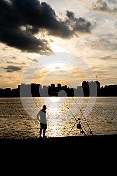 Silhouette of a man, fishing at Han River with the sunsets