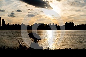 Silhouette of a man, fishing at Han River with the sunsets