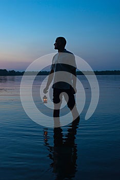Silhouette of a man with a flashlight