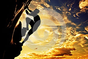 A silhouette of man free climbing on mountain