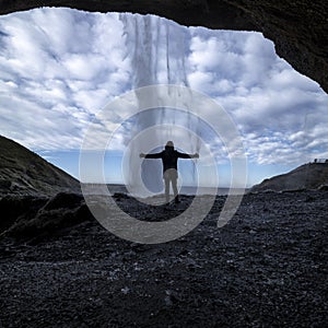 Silhouette of a man in front of the Seljalandsfoss waterfall in Iceland
