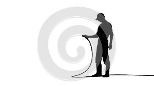 Silhouette of man gardener watering the plants with long garden hose. Isolated on white background alpha channel.