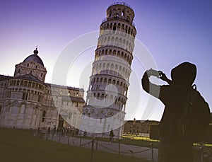 Silhouette man hand he`s a take a picture by smartphone at  Leaning tower in Pisa old town in Italy