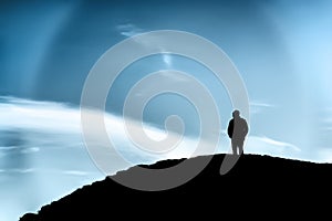 Silhouette of a man on a hill