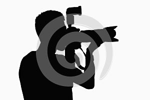 Silhouette of man holding camera.