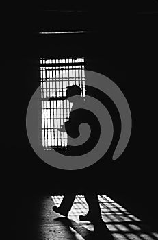 Silhouette of a man inside a prison