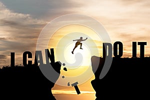 Silhouette man jumping over cliffs for I can do it , good mindset by never give up concept