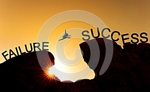 Silhouette a man jumping over precipice from failure to success.Business success, challenge, achievement and leadership concept photo