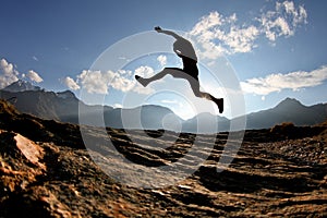 Silhouette of man jumping in swiss alps