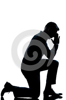 Silhouette man kneeling full length