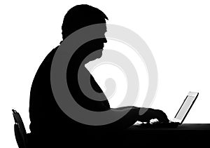 Silhouette of a man lead inactive lifestyle, working on laptop