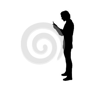 Silhouette of man looking at the phone