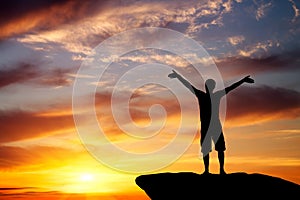 Silhouette of a man on a mountain top