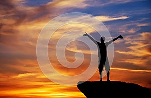 Silhouette of a man on a mountain top