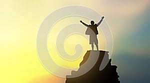 Silhouette of man on mountain top over sky and sun light background,business, success.