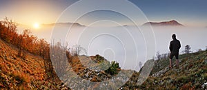 Silhouette of a man on a mountain top. Sport and active life con