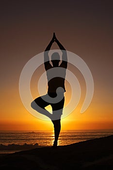 Silhouette, man and namaste with hands for yoga, health and wellness on beach with sunset and zen. Person, shadow and