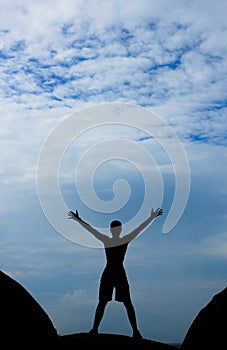 A silhouette of a man with open arms photo