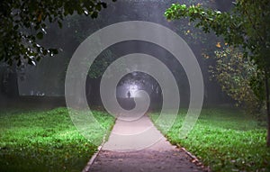 Silhouette of a man in the Park in the fog