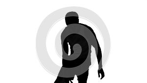 Silhouette of a man playing basket on white background