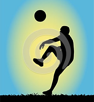 Silhouette of a man playing football