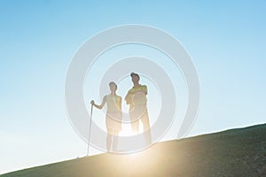 Silhouette of a man pointing while standing next to his partner