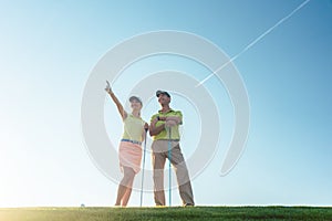 Silhouette of a man pointing while standing next to his partner