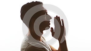 Silhouette of a man praying to God. Concept of faith and religion