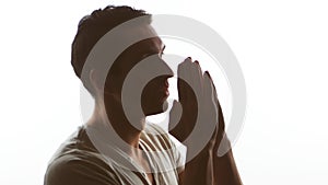 Silhouette of a man praying to God. Concept of faith and religion