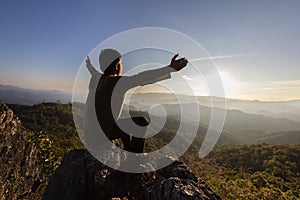 Silhouette of a man praying to god on the mountain Pray with hands with faith in religion and belief in God on blessing basis. the