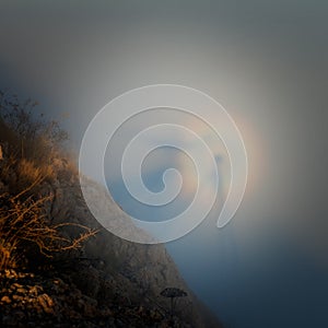 Silhouette of a man with a rainbow in the clouds