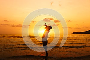 Silhouette of Man Raising His Hands or Open arms  with sunset on the beach